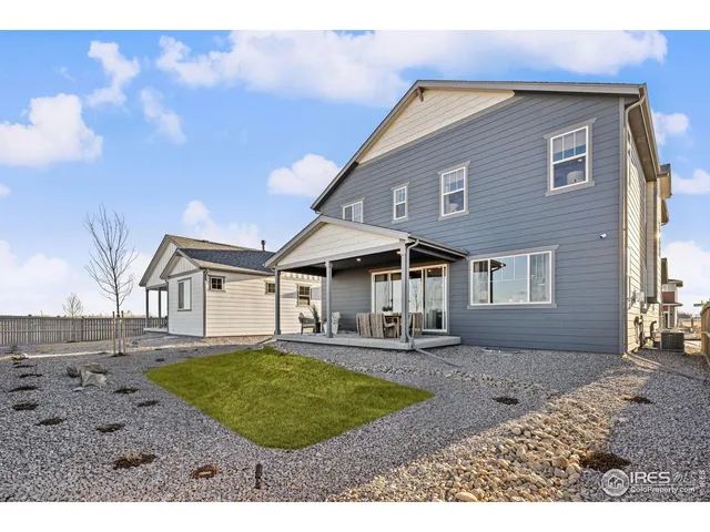a balcony with wooden floor table and chairs