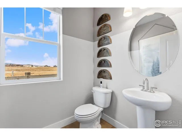 a living room with a table chairs and a chandelier
