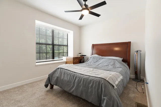 a bedroom with a bed and window
