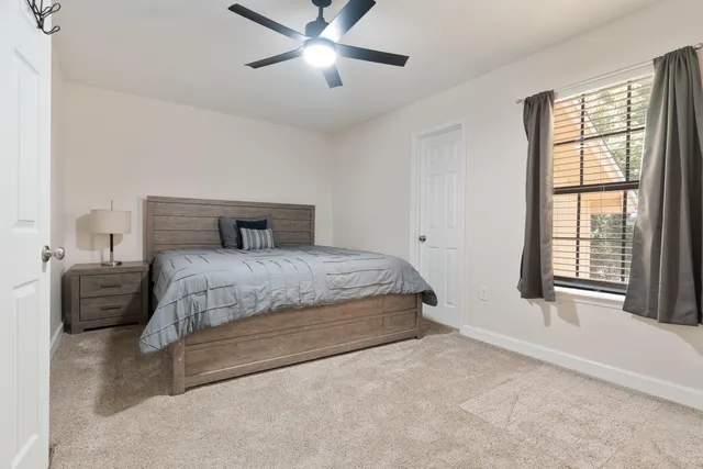 a bedroom with a large bed and a chandelier