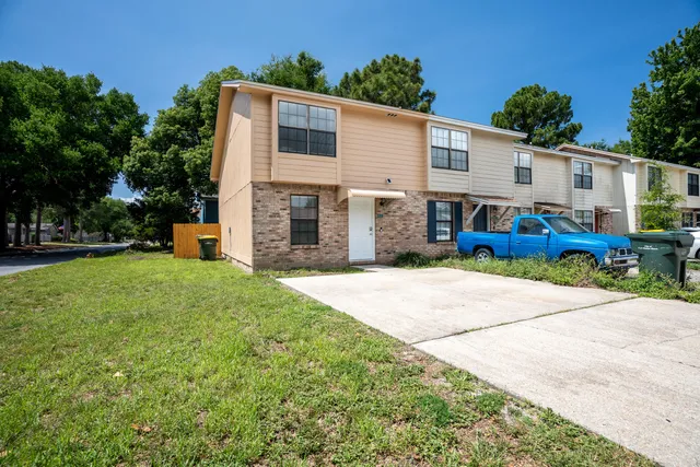 a view of backyard of house with outdoor seating and green space