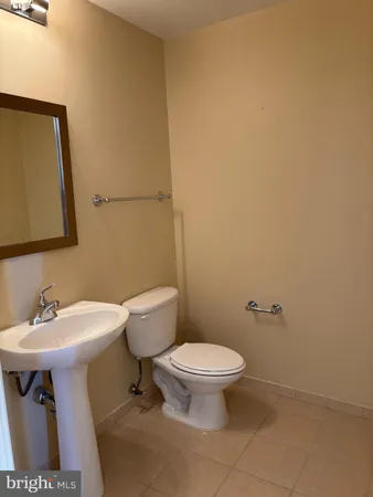 a white toilet sitting next to a bathroom sink