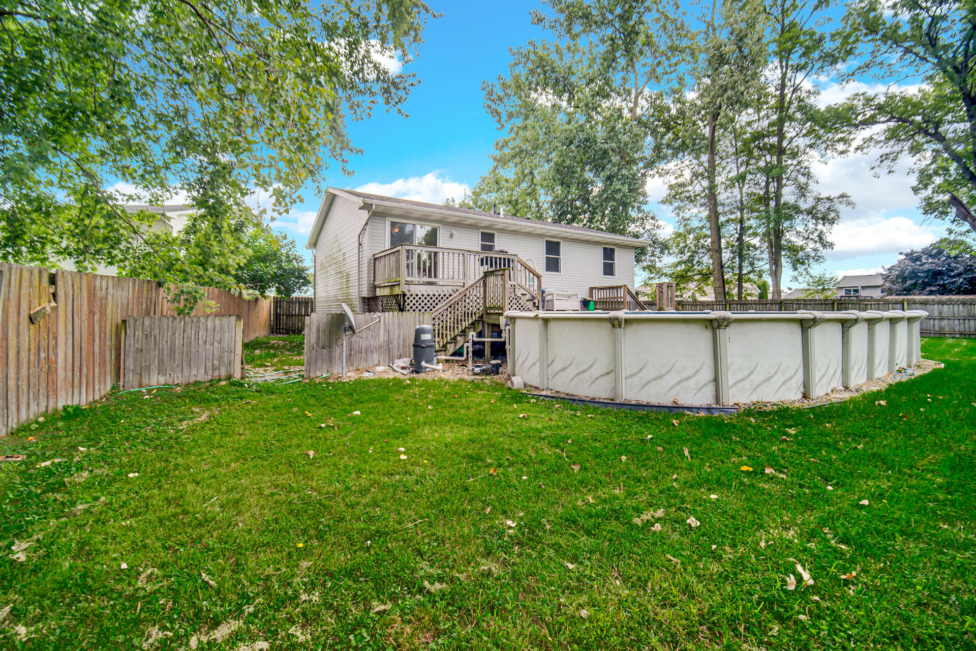 3716 Walsh Street Portage, IN 46368 - Photo 21 of 24 a view of a backyard with wooden fence and large trees