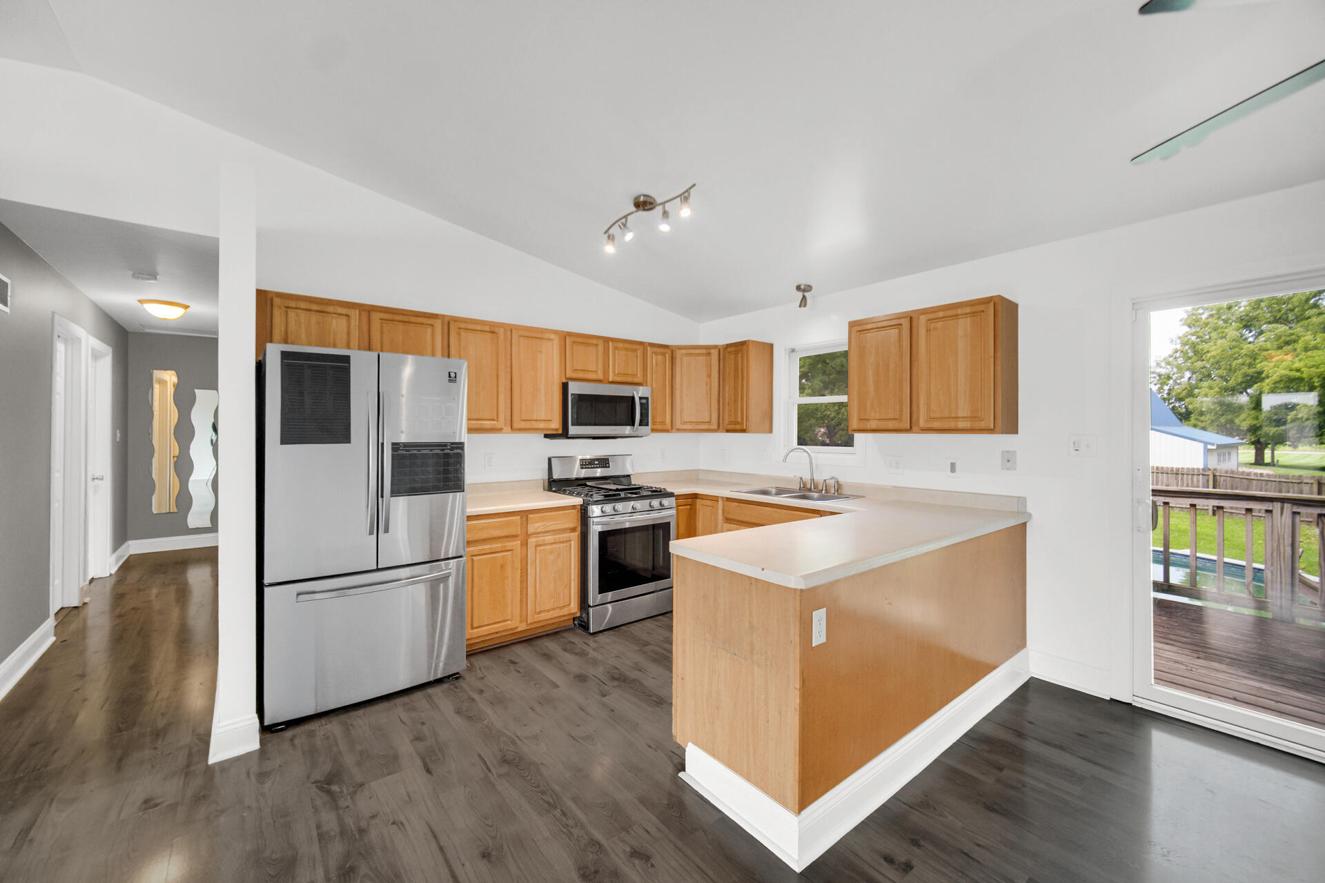 3716 Walsh Street Portage, IN 46368 - Photo 4 of 24 a kitchen with stainless steel appliances granite countertop a refrigerator a stove and a wooden floors