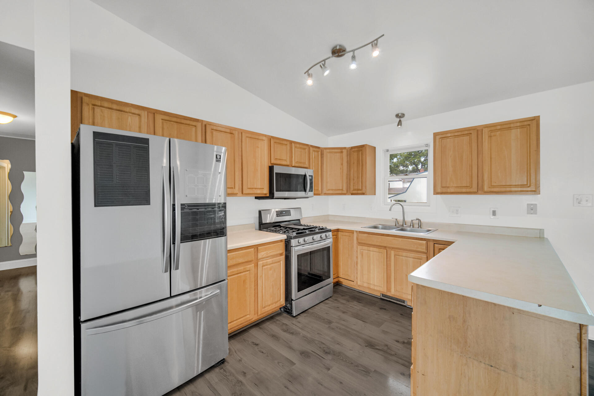 3716 Walsh Street Portage, IN 46368 - Photo 5 of 24 a kitchen with stainless steel appliances granite countertop a refrigerator a sink dishwasher a stove top oven a refrigerator with white cabinets and wooden floor