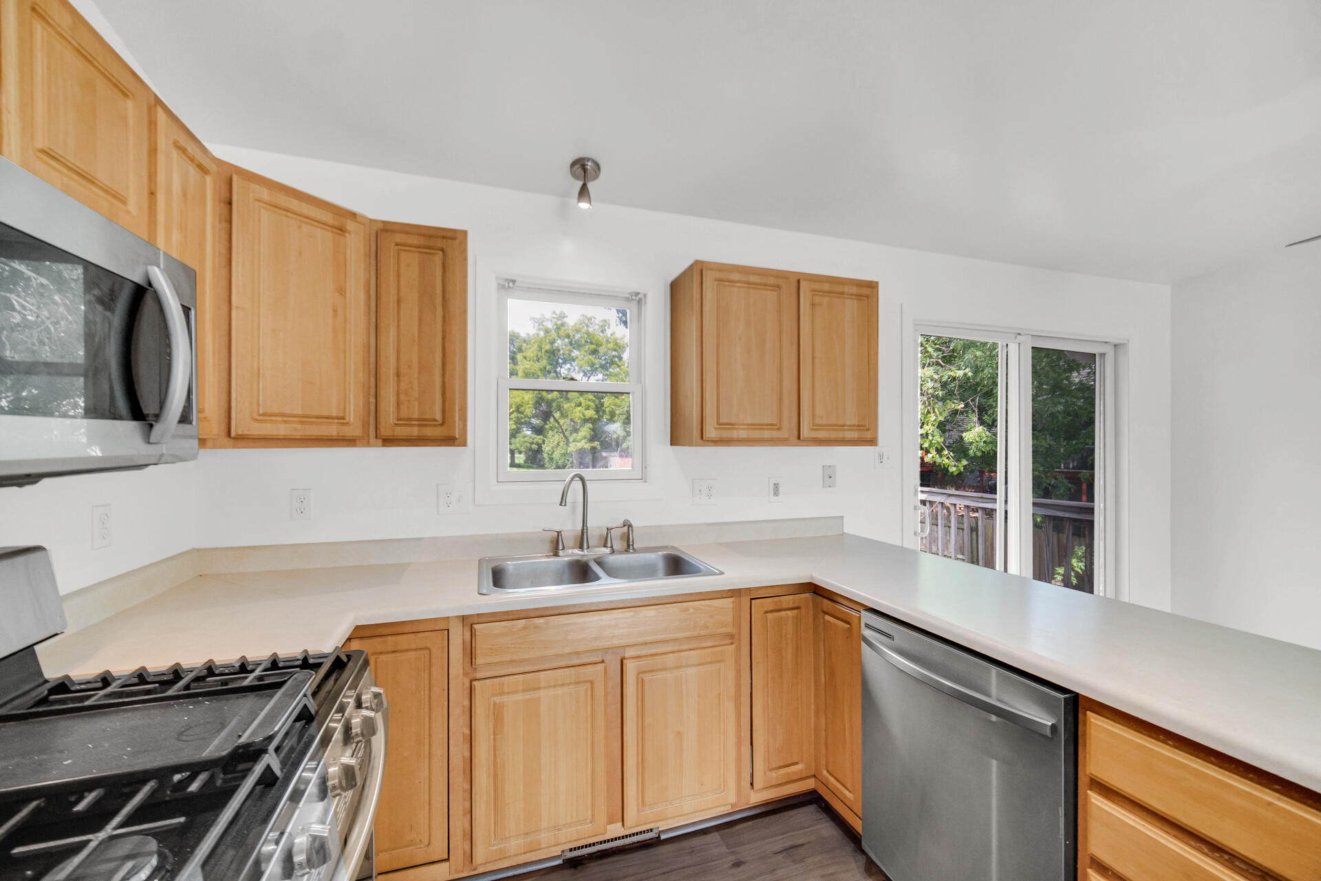 3716 Walsh Street Portage, IN 46368 - Photo 6 of 24 a kitchen with granite countertop a sink a stove and cabinets