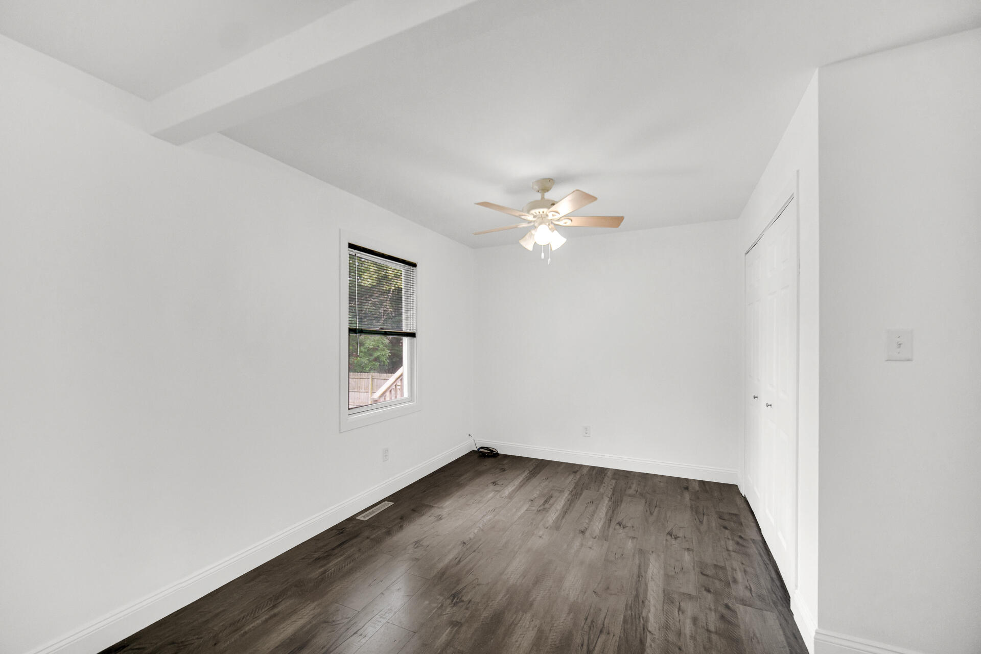 3716 Walsh Street Portage, IN 46368 - Photo 9 of 24 a view of an empty room with wooden floor and a window