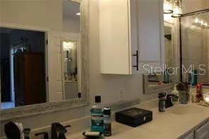 a bathroom with a sink and mirror with toilet