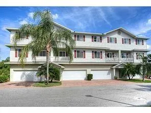 an aerial view of a house with swimming pool and outdoor seating