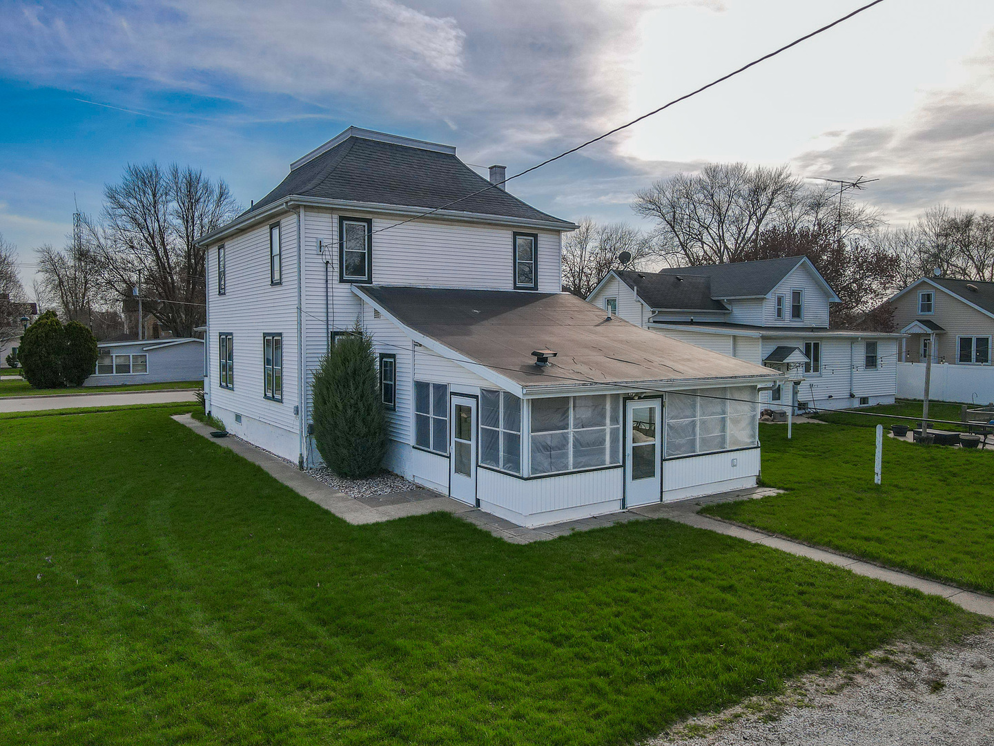 141 West 1st Street Manteno, IL 60950 - Photo 4 of 16 a view of a house with a big yard and large trees
