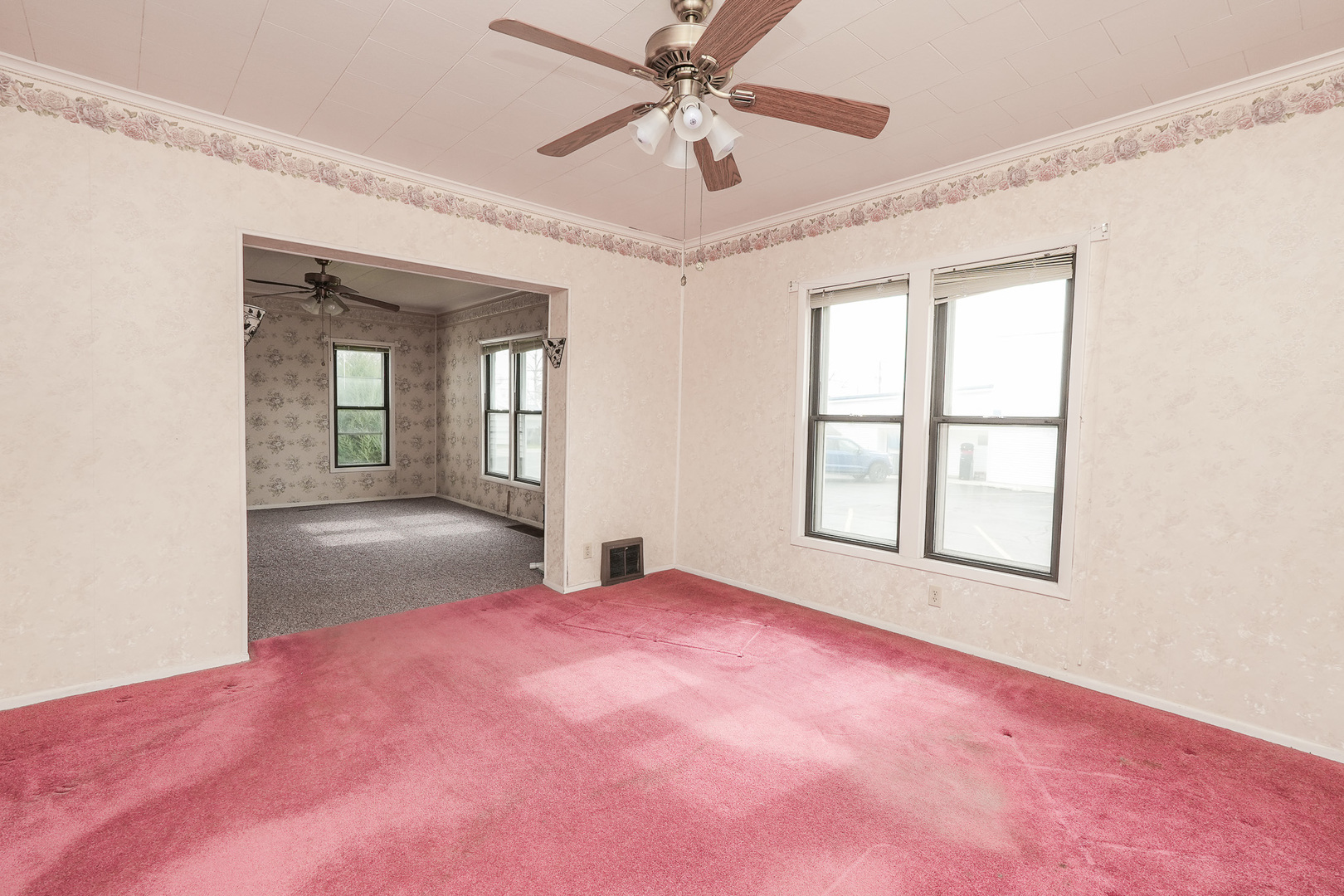 141 West 1st Street Manteno, IL 60950 - Photo 5 of 16 an empty room with chandelier fan and windows