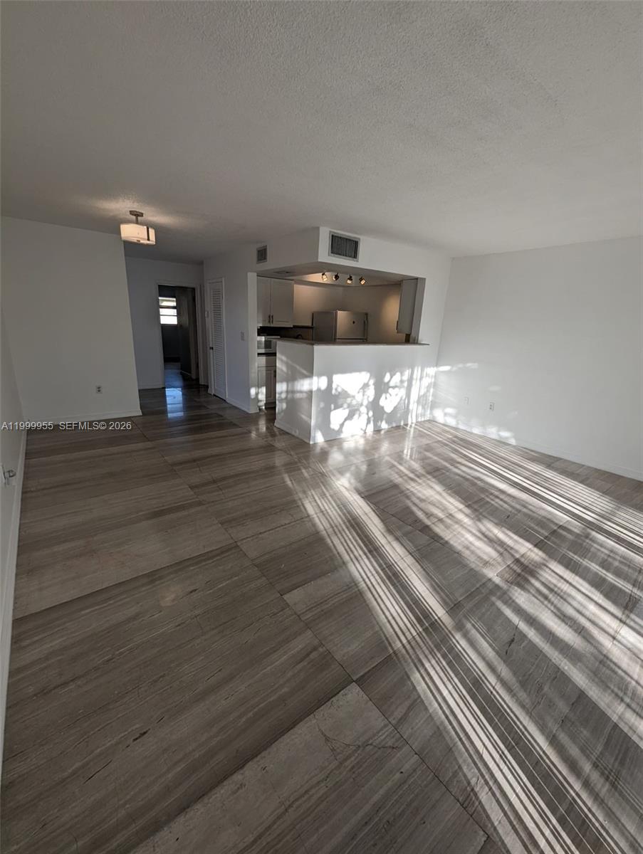 7360 Southwest 82nd Street, Unit E202 Miami, FL 33143 - Photo 3 of 11 a view of a room with wooden floor