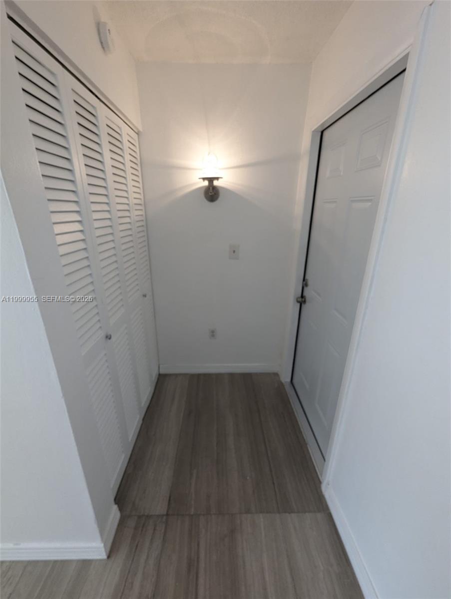 7360 Southwest 82nd Street, Unit E202 Miami, FL 33143 - Photo 7 of 11 a view of hallway with wooden floor