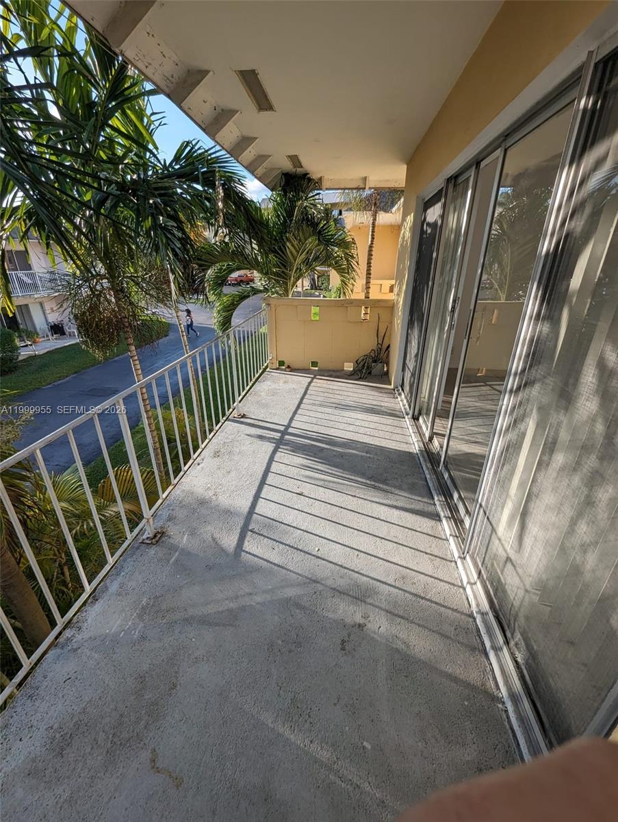 7360 Southwest 82nd Street, Unit E202 Miami, FL 33143 - Photo 9 of 11 a view of balcony with wooden floor