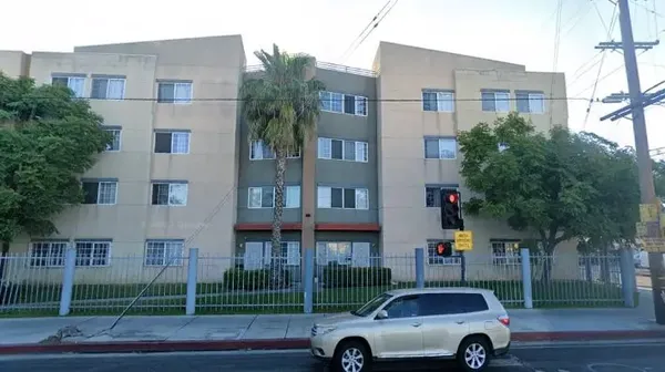 a front view of a building with parking space