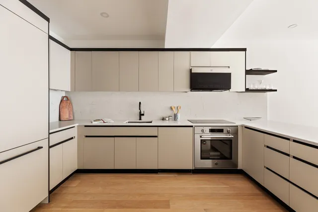 a kitchen with stainless steel appliances a sink and a microwave