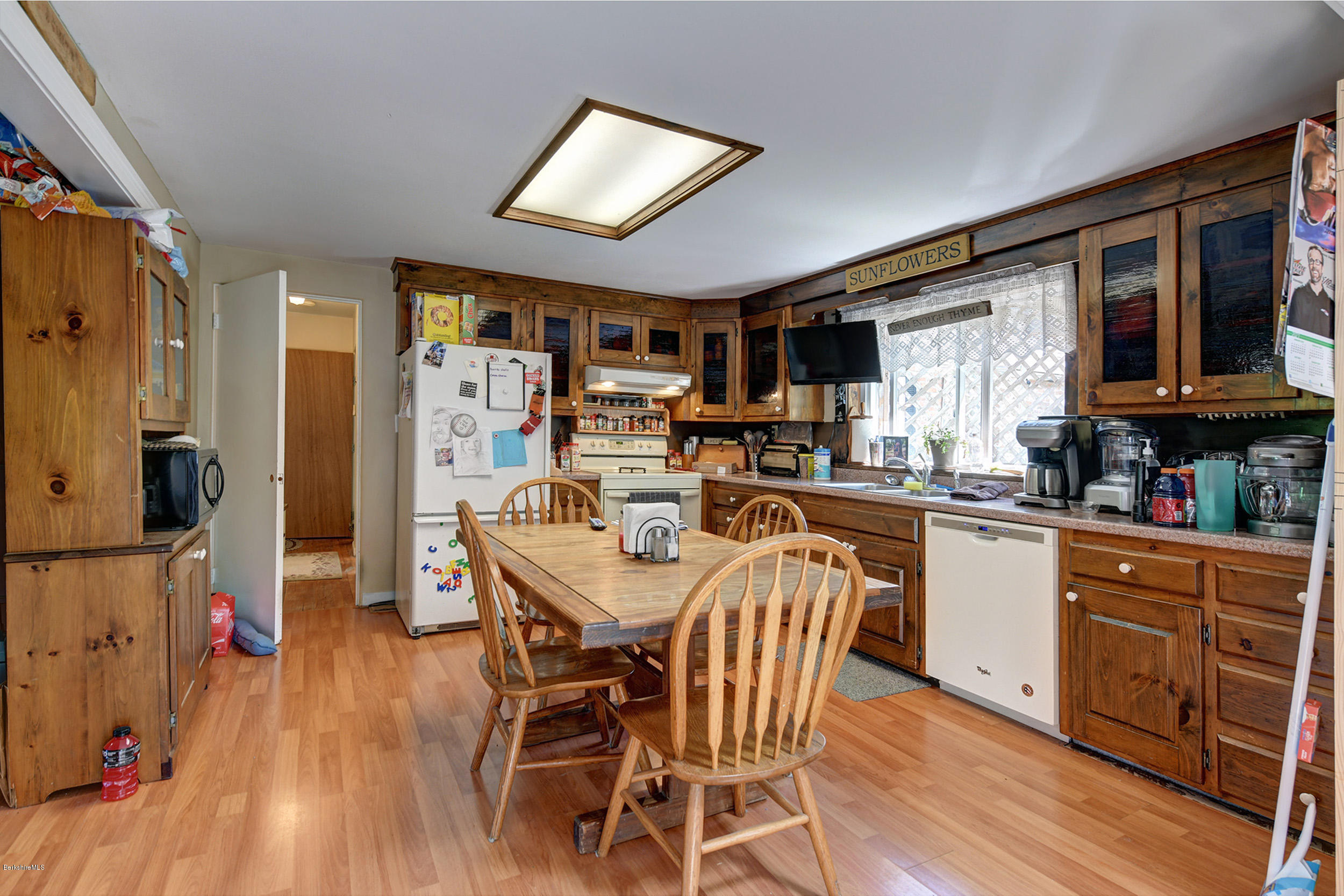 2175 Swamp Road Richmond, MA 01254 - Photo 10 of 33 a kitchen with stainless steel appliances kitchen island granite countertop a refrigerator a stove a microwave oven a dining table and chairs with wooden floor