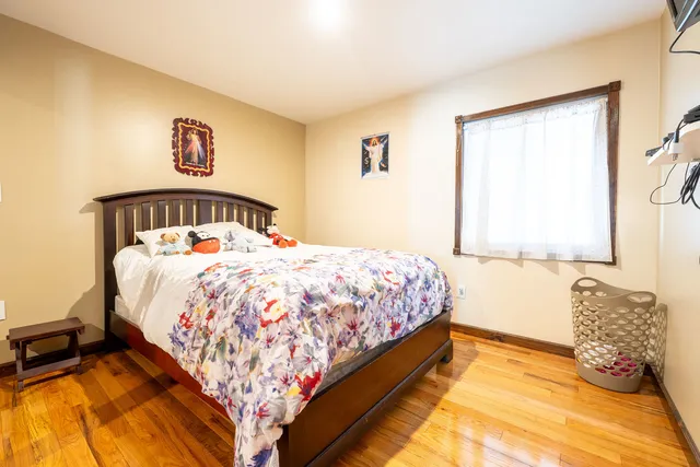 a bed sitting in a bedroom next to a window