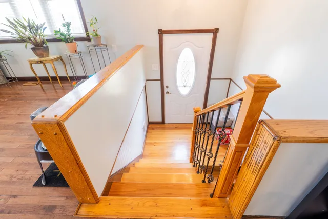 a view of an entryway with wooden floor and door