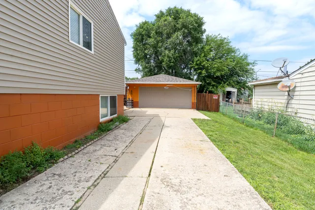 a backyard of a house with table and chairs
