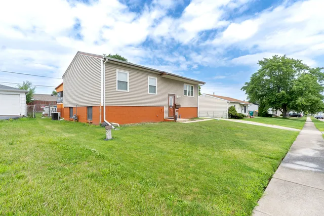 a backyard of a house with table and chairs