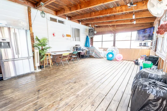 a living room with a couch and wooden floor