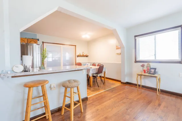 a view of a dining room with furniture and wooden floor