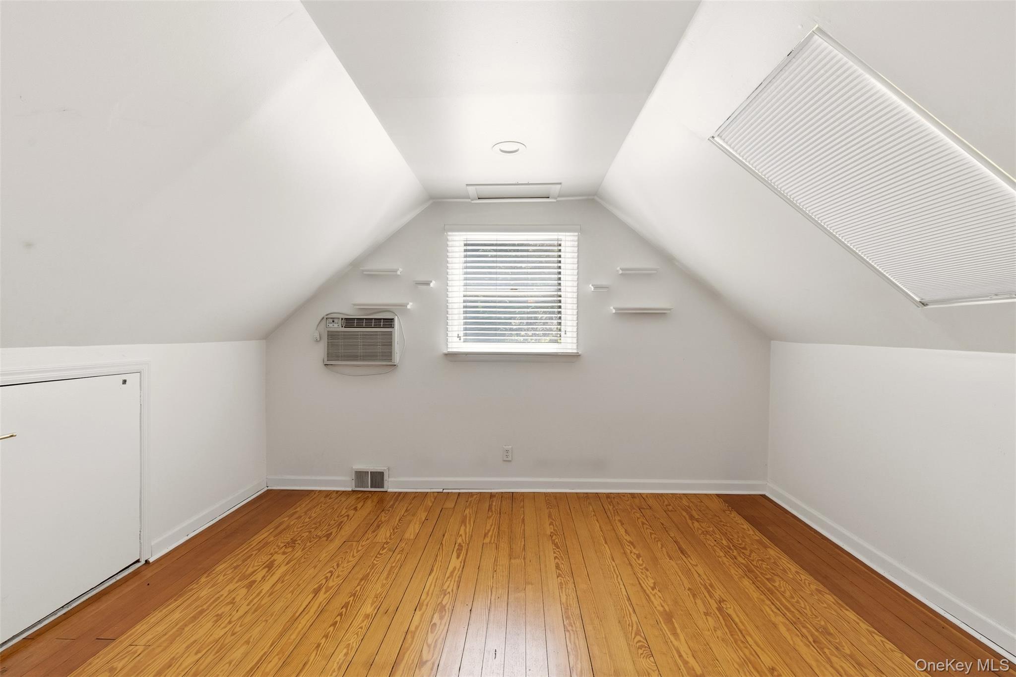 106 Vineyard Road Huntington, NY 11743 - Photo 19 of 25 an empty room with wooden floor and windows