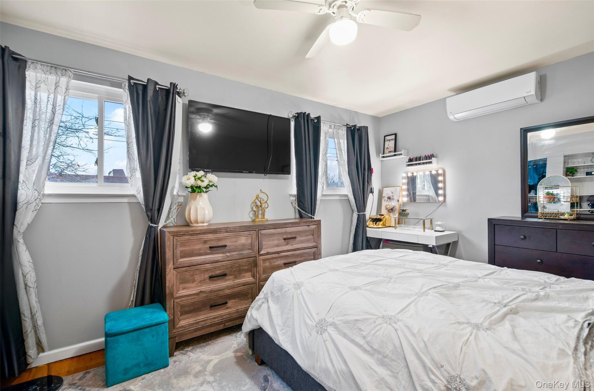 113-34 Springfield Boulevard Queens, NY 11429 - Photo 11 of 26 a bedroom with a bed and a flat tv screen on dresser