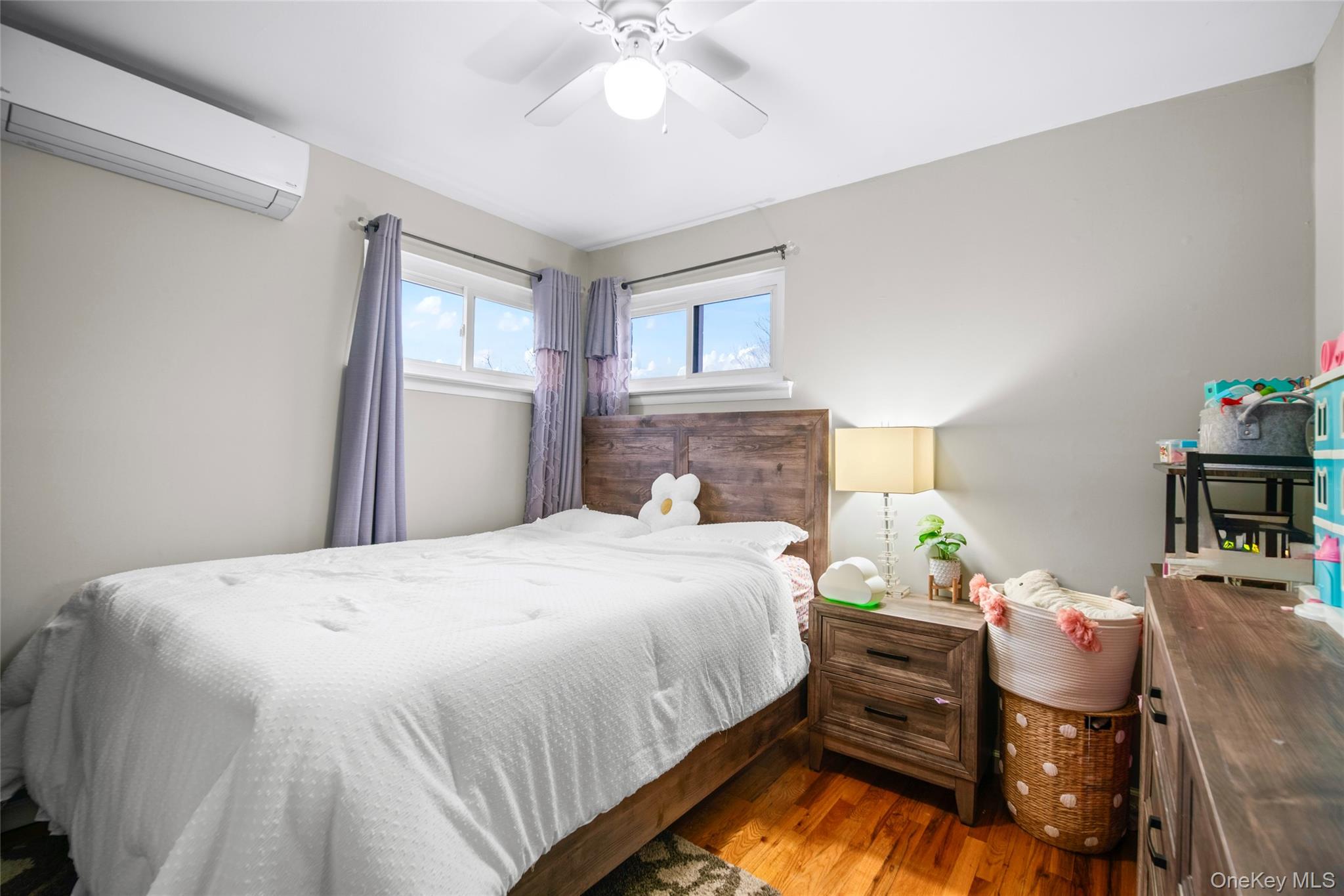 113-34 Springfield Boulevard Queens, NY 11429 - Photo 14 of 26 a bedroom with a bed and a chandelier