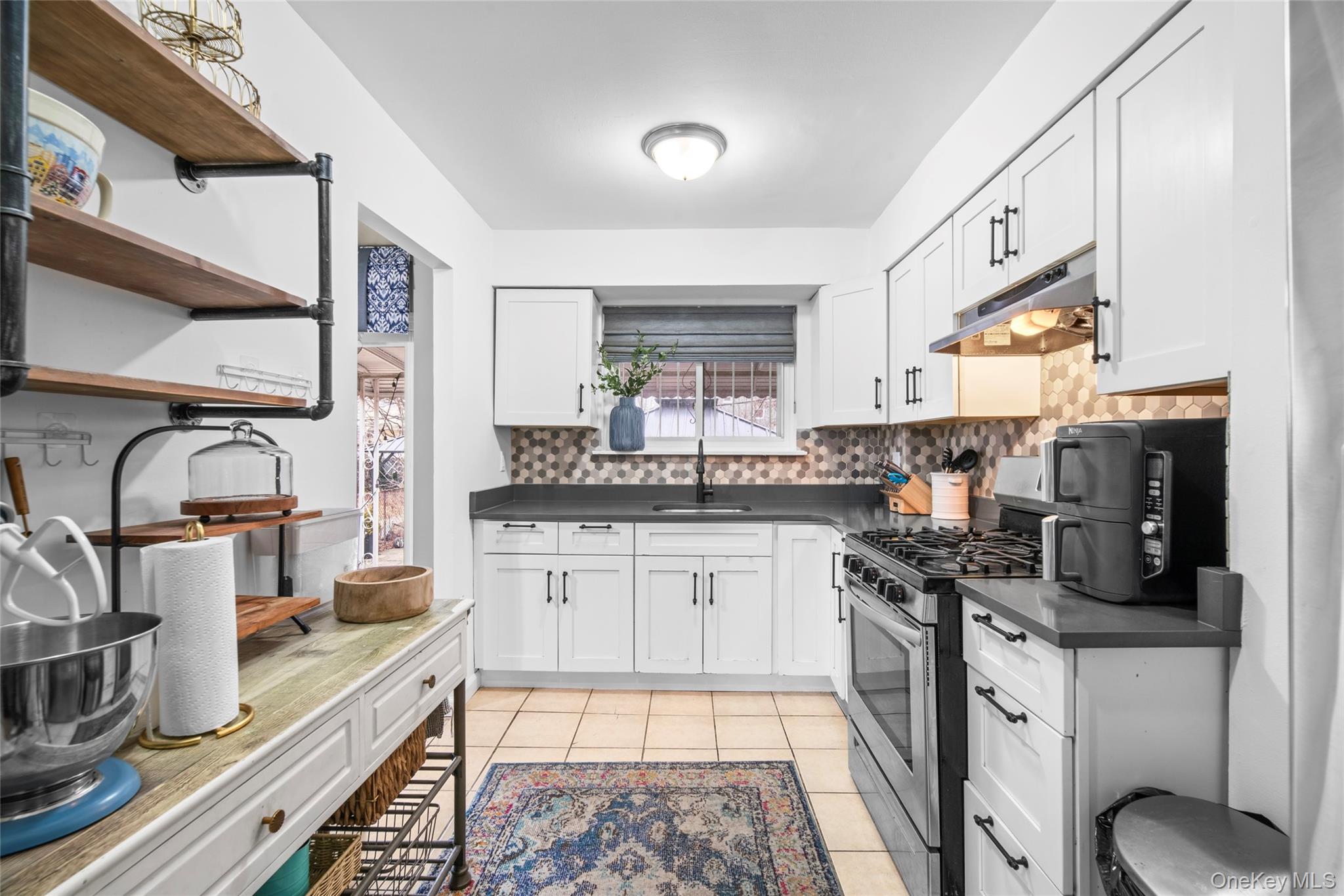 113-34 Springfield Boulevard Queens, NY 11429 - Photo 7 of 26 a kitchen with stainless steel appliances granite countertop a stove a sink dishwasher and a refrigerator