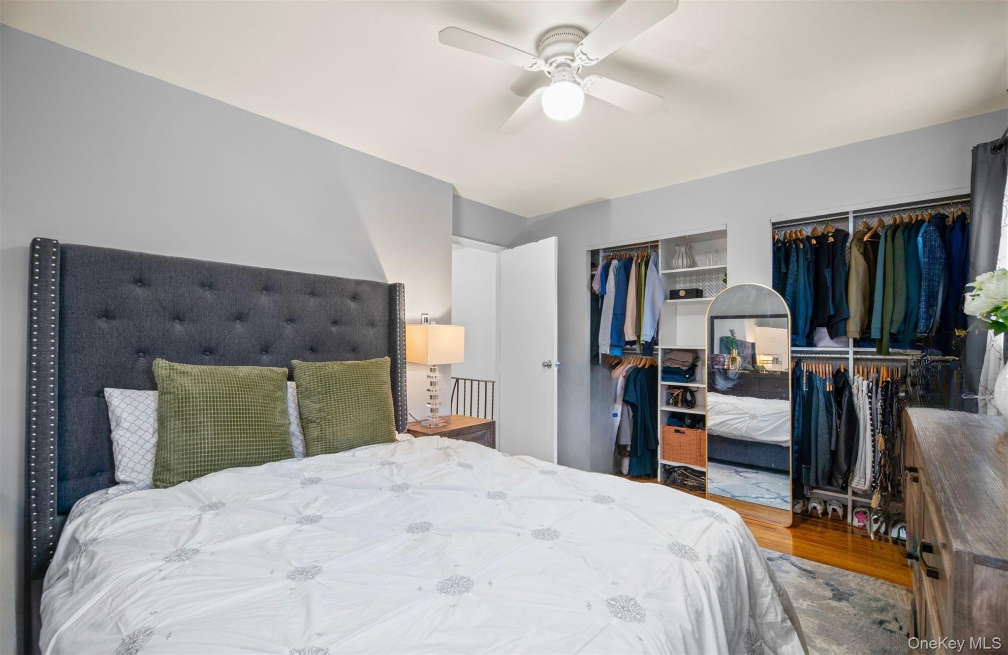 113-34 Springfield Boulevard Queens, NY 11429 - Photo 10 of 26 a bedroom with a bed and a chandelier