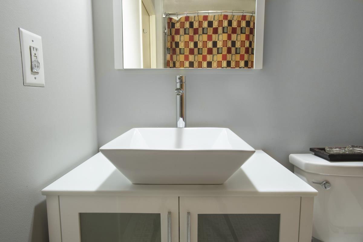 700 Grove Street, Unit 12J Jersey City, NJ 07310 - Photo 13 of 16 a bathroom with a sink and a mirror
