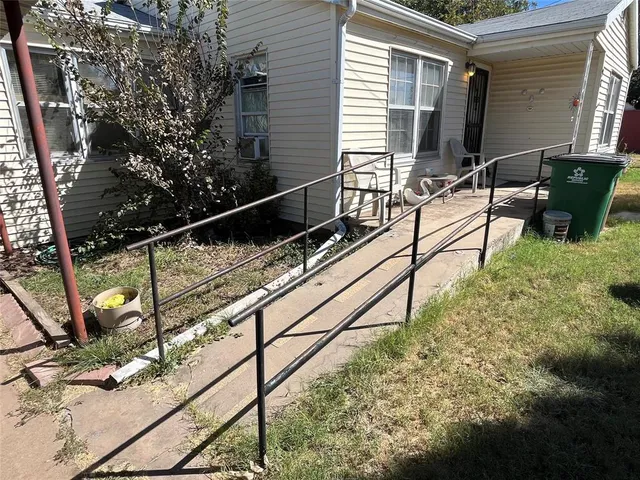 a view of a house with backyard and sitting area