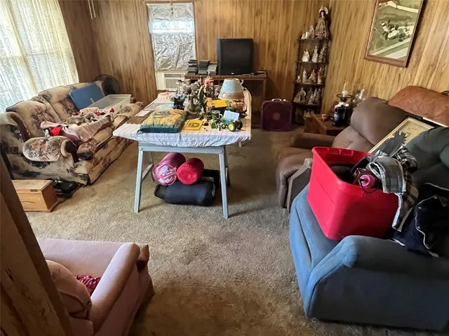 a living room with furniture toys and a window