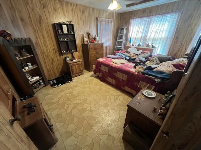 a bed room with a bed and a flat tv screen