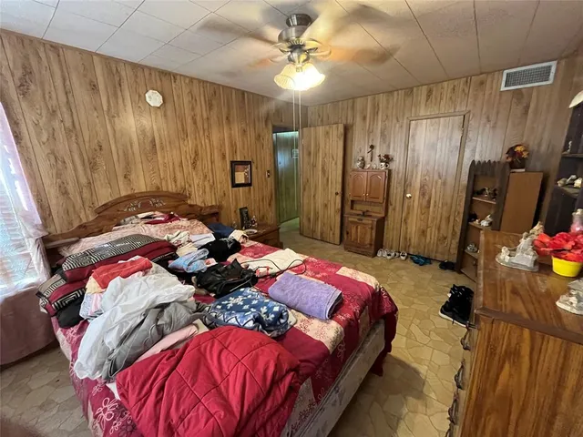 a bedroom with a bed and a mirror