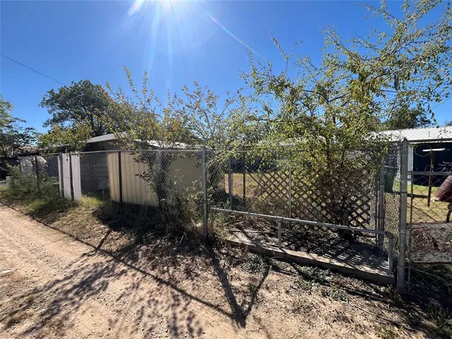 a view of a house with a tree in the background