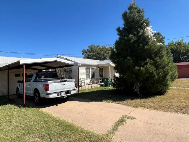 a view of house with outdoor space and car parked