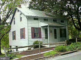 5192 Lehman Road Spring Grove, PA 17362 - Photo 1 of 1 a view of a white house with large windows and a table and chairs