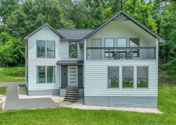 a front view of a house with a yard