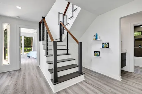 a view of entryway and hall with wooden floor