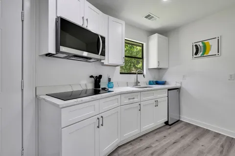 a kitchen with a sink and a microwave