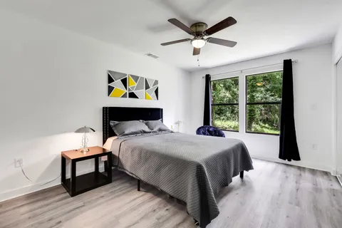 a bedroom with a bed and a large window
