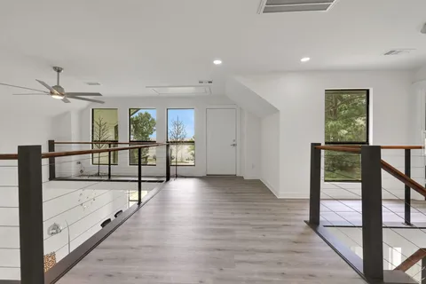 a view of a hallway with wooden floor