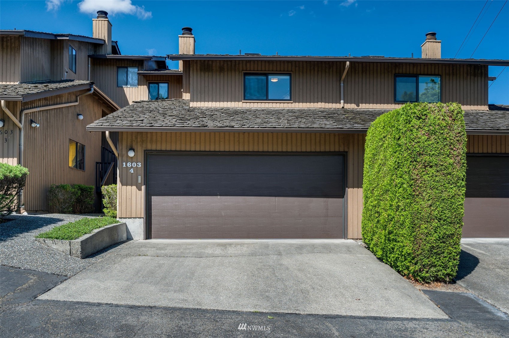 1603 Eagle Ridge Drive South, Unit D4 Renton, WA 98055 - Photo 1 of 30 a front view of a house with garden