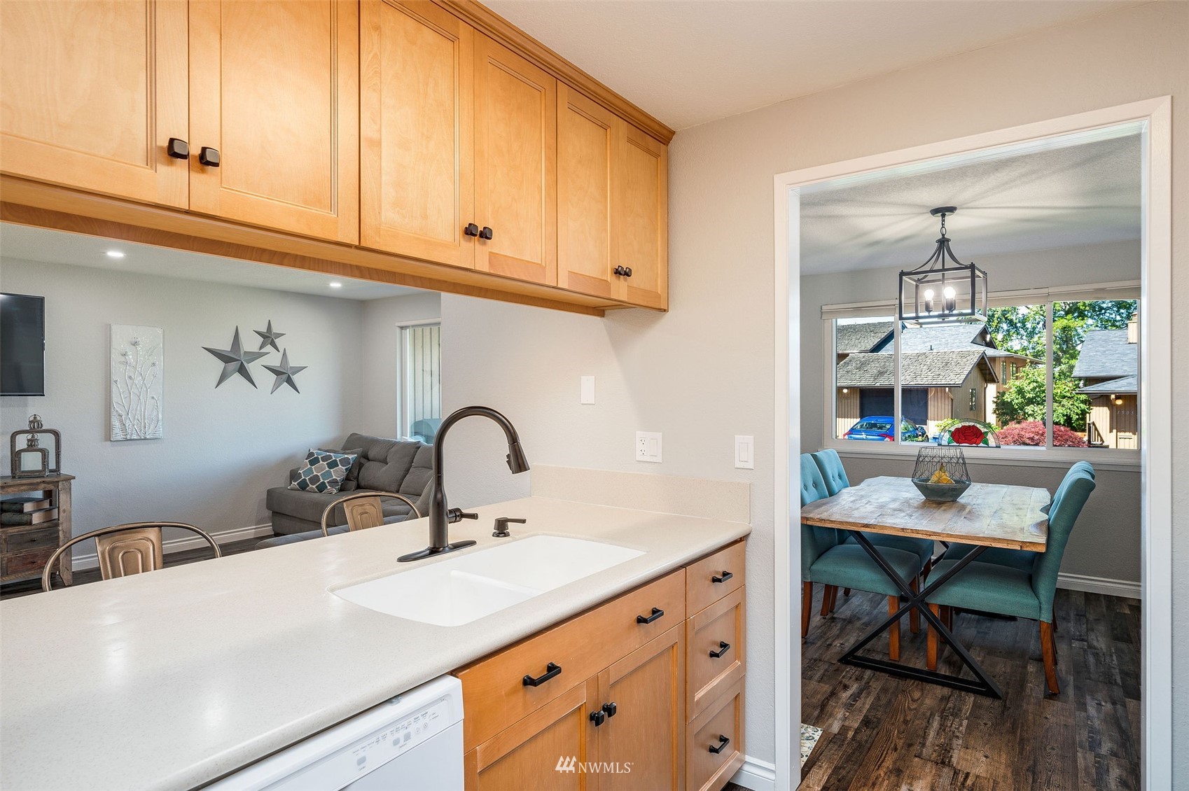 1603 Eagle Ridge Drive South, Unit D4 Renton, WA 98055 - Photo 11 of 30 a kitchen with a sink cabinets and dining table chair