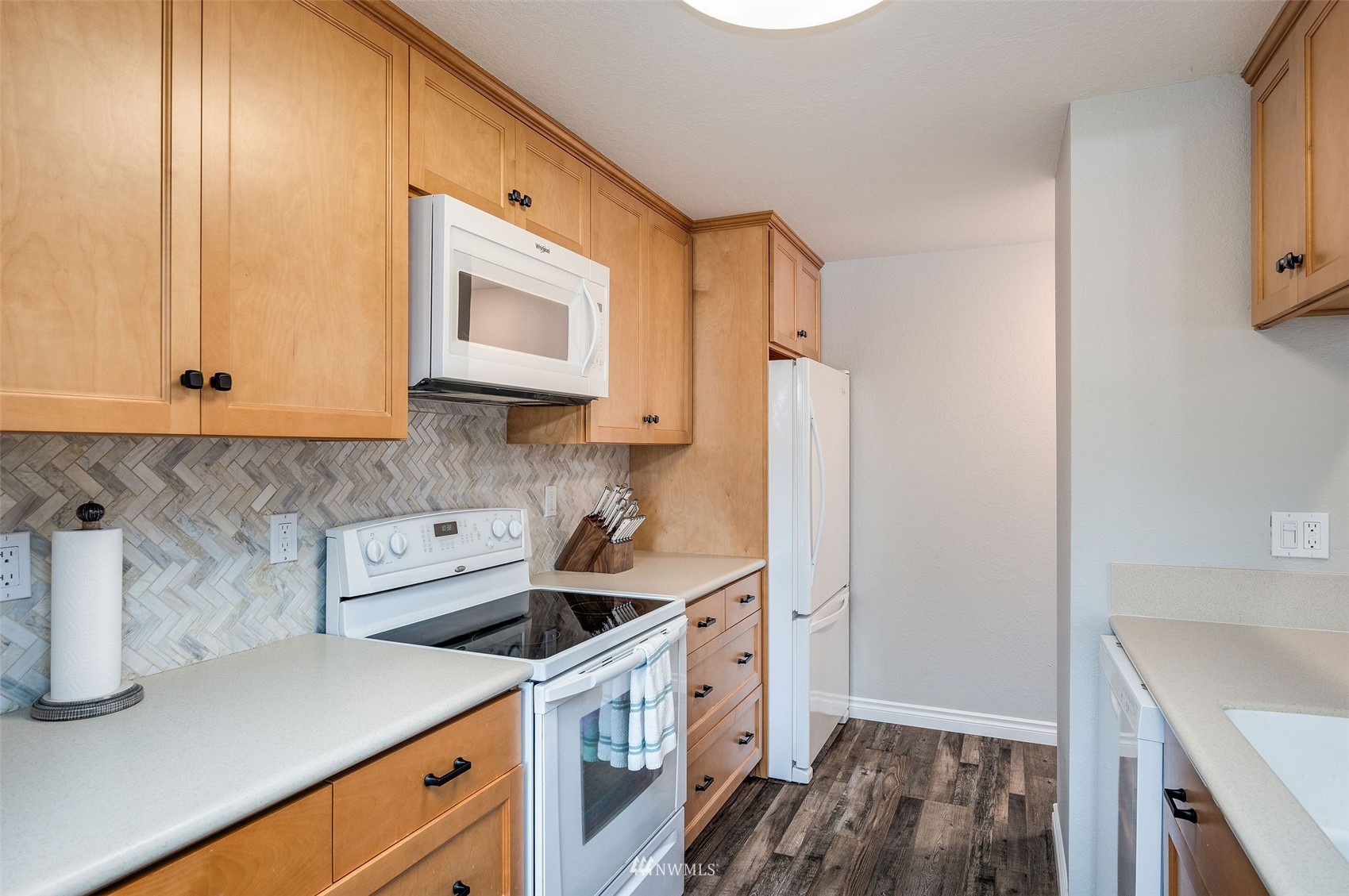 1603 Eagle Ridge Drive South, Unit D4 Renton, WA 98055 - Photo 12 of 30 a kitchen with stainless steel appliances white cabinets and a stove top oven
