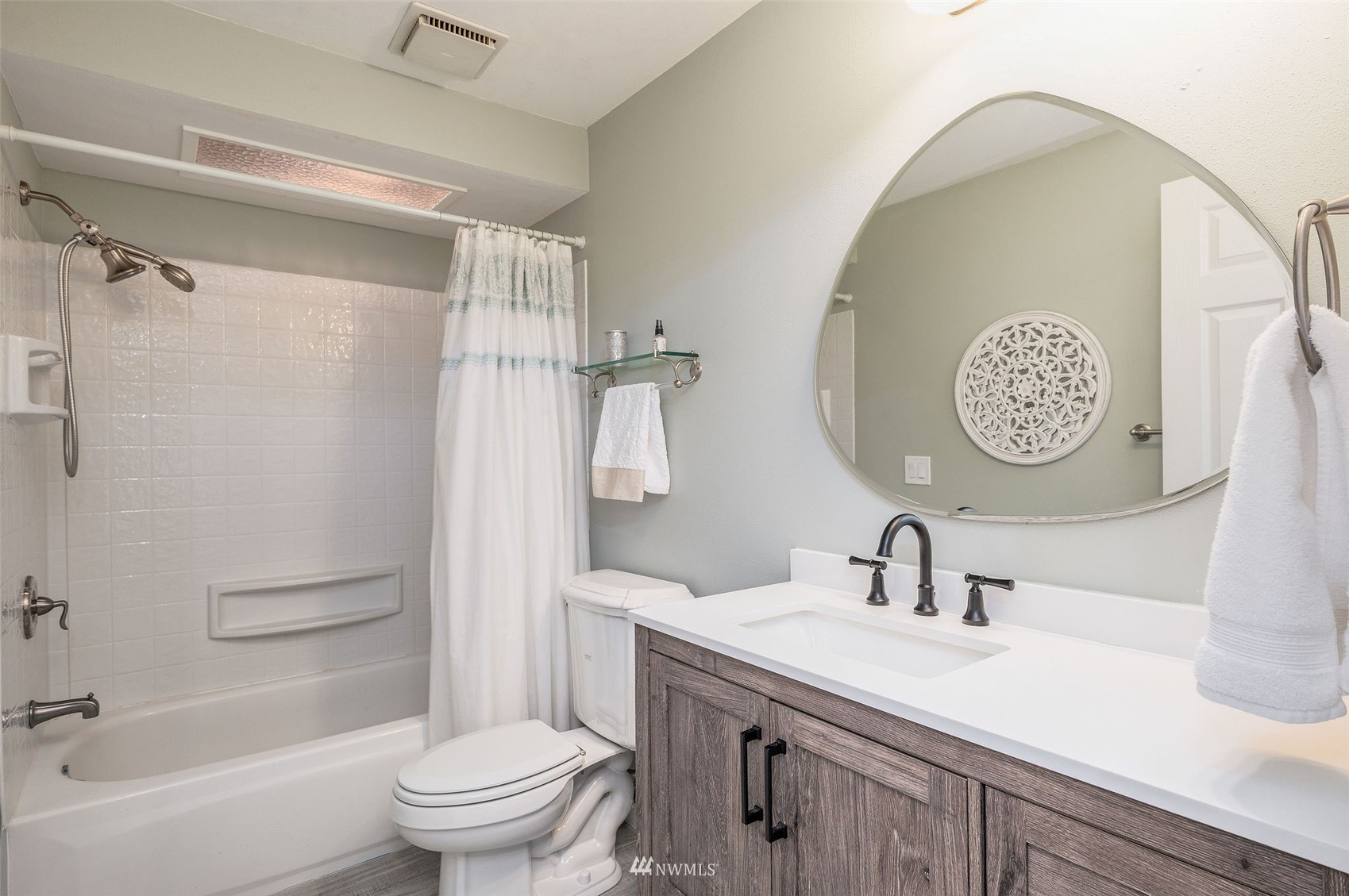 1603 Eagle Ridge Drive South, Unit D4 Renton, WA 98055 - Photo 14 of 30 a bathroom with a sink a toilet and a mirror