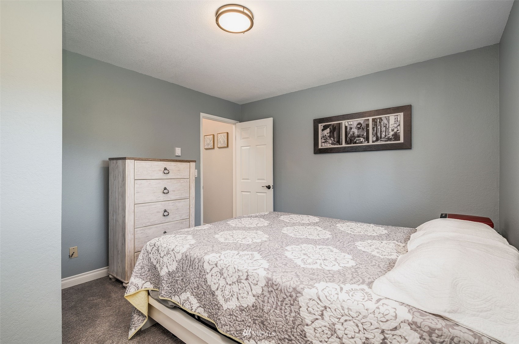 1603 Eagle Ridge Drive South, Unit D4 Renton, WA 98055 - Photo 17 of 30 a bedroom with a bed and cabinets